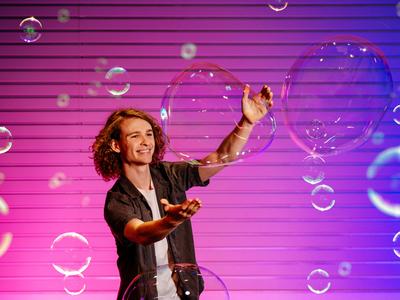 Young man with huge soap bubbles